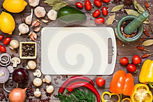 Frame of different fresh organic vegetables and spices on wooden table. Healthy natural food background with copy space.