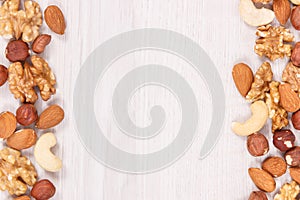 Frame of different nuts and almonds as source vitamins and minerals, copy space for text