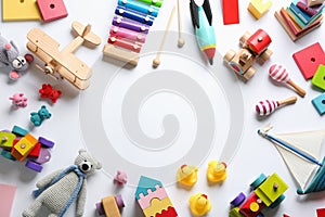 Frame of different toys on white background, flat lay. Space for text