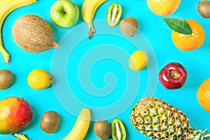 Frame from Different Tropical and Seasonal Summer Fruits. Pineapple Mango Coconut Citrus Orange Lemons Apples Kiwi Bananas on Blue