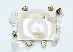 Frame with easter eggs,rabbit  and feathers.