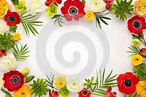 Frame flowers composition. Arrangement of anemones, roses, ranunculus, tropical flowers, succulent and leaves on light background