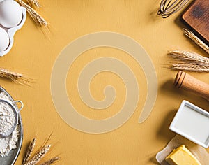 Frame of food ingredients for baking on a yellow background. Cooking flat lay with copy space. Top view. Baking concept. Mockup