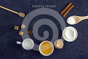 Frame of food Ingredients and utensils for cooking cake flour, egg, milk, rolling pin, wooden spoon on dark table. Food concept