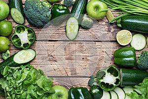 Frame forms the heart Fresh green vegetables and herbs on a wooden background. Copy space