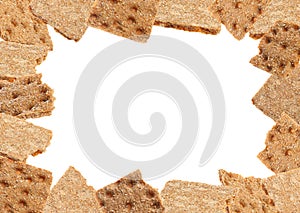 Frame of fresh crunchy rye crispbreads on white background, space for text