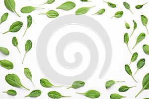 Frame of fresh green healthy spinach on white, top view. Space for text