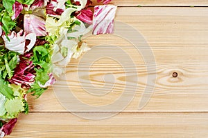 Frame of fresh green salad on wooden background. Healthy natural food . mockup for recipe or menu.