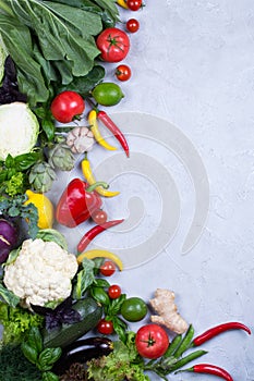 Frame of fresh organic vegetables on a gray concrete background . Healthy natural food top view, copy space .