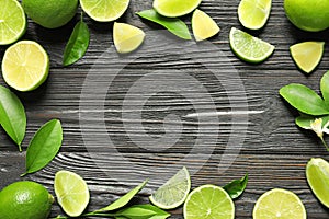 Frame of fresh ripe limes on wooden background,