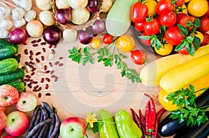 Frame of fresh vegetables and fruits on a white wooden table