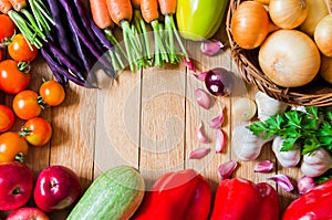 Frame of fresh vegetables and fruits on wooden table