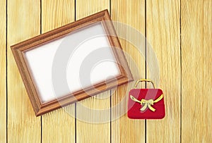 Frame and gift box on the background of wooden laths