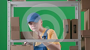 In the frame on a green background, a limp. Depicts a young woman in a uniform. Depicts an employee, in a warehouse. She