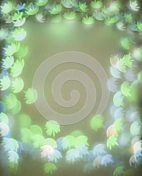 Frame with green and blue bokeh lights with flower shapes