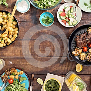 Frame of grilled steak, vegetables, potatoes, salad, snacks, homemade lemonade