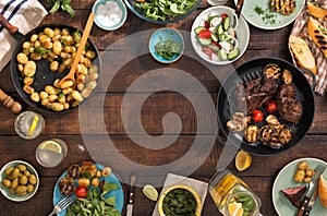 Frame of grilled steak, vegetables, potatoes, salad, snacks, homemade lemonade