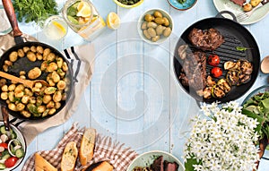 Frame of grilled steak, vegetables, potatoes, salad, snacks, lemonade