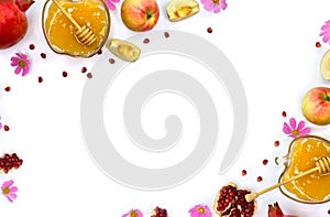 Frame of honey in glass bowl, red apples, garnets, wooden honey dipper, pink flowers on a white background with space for text.