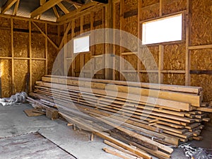 Frame house made of timber. Lumber in the pile