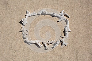 Frame of inscription of coral debris on the sand.