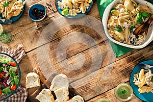 Frame of Italian pasta, salad and wine