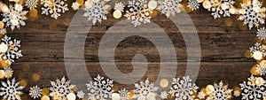 Frame of lights bokeh golden flares and ice crystals, isolated on rustic brown wooden texture - Holiday New Year`s Eve Silvester
