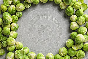 Frame made with Brussels sprouts on grey background, top view.