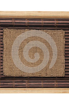 Frame made of burlap lying on a bamboo mat in the form of manuscript