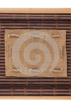 Frame made of burlap lying on a bamboo mat in the form of manuscript