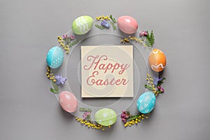 Frame made of colorful painted eggs and card with text Happy Easter on color background