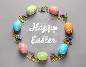 Frame made of colorful painted eggs and text Happy Easter on color background