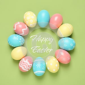 Frame made of colorful painted eggs and text Happy Easter on color background