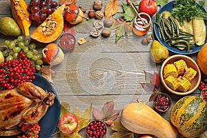 Frame made of delicious turkey, autumn vegetables and fruits on background, flat lay with space for text. Happy