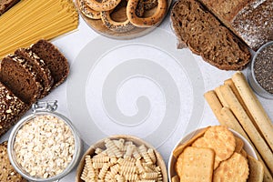 Frame made of different gluten free products on white table, flat lay. Space for text
