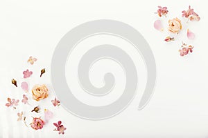 Frame made of dried rose flowers, hydrangea on white background. Top view, flat lay. Copy space. Birthday