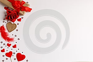 Frame made of girt box  rose flower red hearts different shape and size on white background. Flat lay