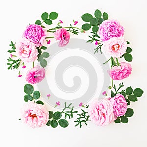 Frame made of pink flowers - roses and peonies with leaves on white background. Floral composition. Flat lay, top view.