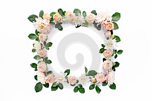 Frame made of pink roses, green leaves eucalyptus, branches, floral pattern on white background. Flat lay, top view