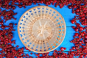 Frame made of red currant and cherry with wicker basket