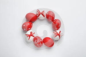 Frame made of red painted Easter eggs on white, space for text