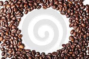 Frame made of roasted coffee beans on white background