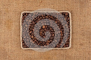 Frame made of rope with coffee beans on sackcloth, view from above