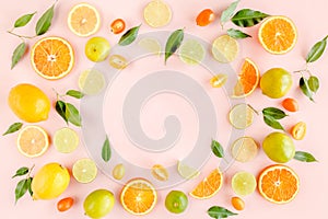 Frame made of summer tropical fruits: orange, lemon, lime, mango on pink background. Food concept. flat lay, top view