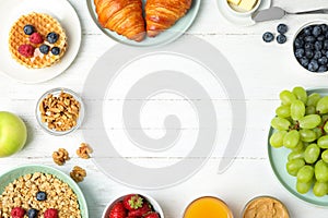 Frame made with tasty meal for breakfast on wooden table, flat lay. Space for text