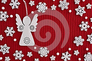 Frame made of wooden Christmas decorations on red knitted background. Top view, flat lay, copy space