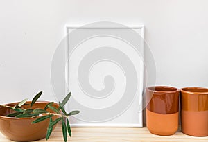 Frame mockup, earthenware glazed crockery, olive tree branch on white background, styled image for social media