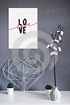 Frame mockup on a gray background in the interior Minimalism. Concept Symbol of love and Valentine's Day. Home Decor