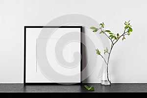 Frame mockup. Poster with plant in vase. Black square photo frame with passepartout