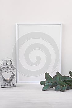Frame mockup, vintage candle holder, branches of green eucalyptus on white background